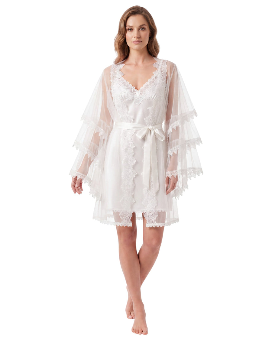 A woman modeling a white lace and tulle nightgown with tiered flutter sleeves and a matching waist tie