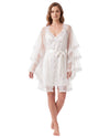 A woman modeling a white lace and tulle nightgown with tiered flutter sleeves and a matching waist tie