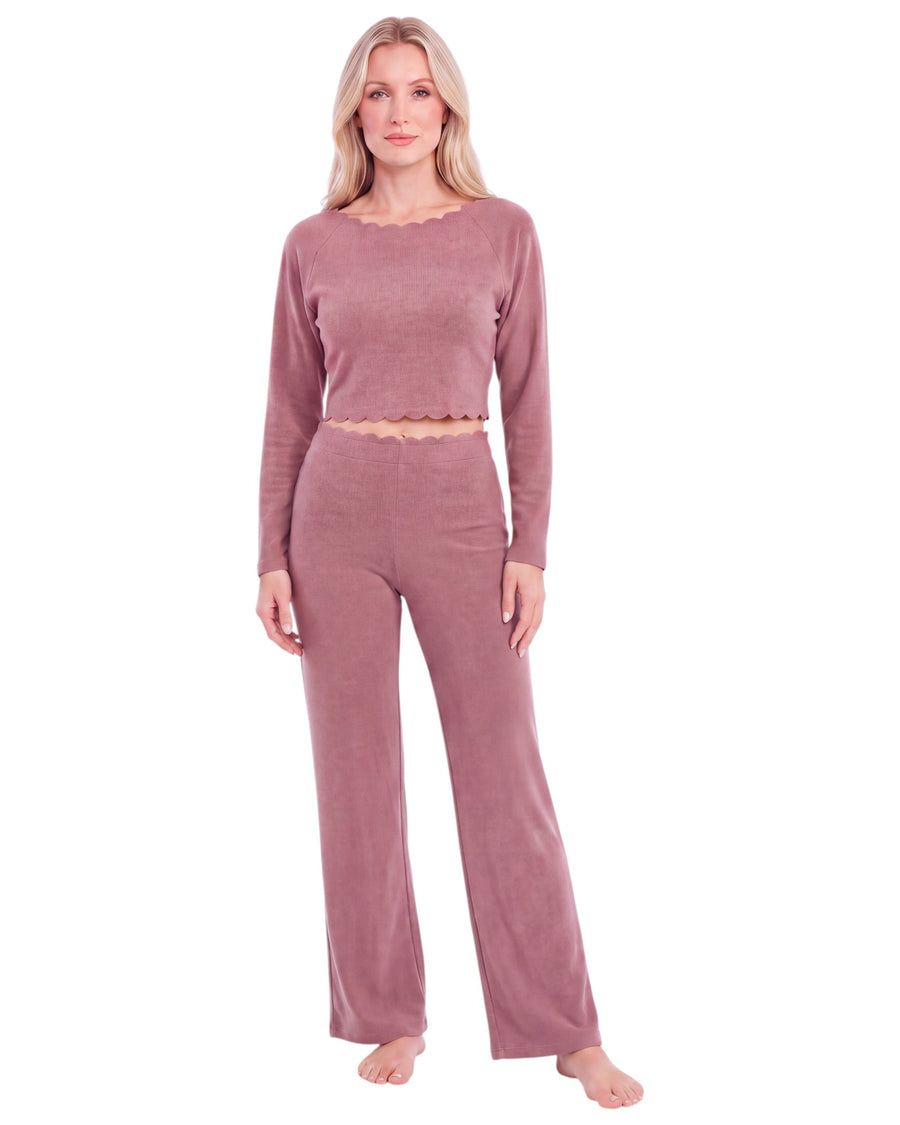 A woman modeling a dusty rose two-piece lounge set consisting of a long-sleeve cropped top with a scalloped neckline and matching high-waisted wide-leg pants