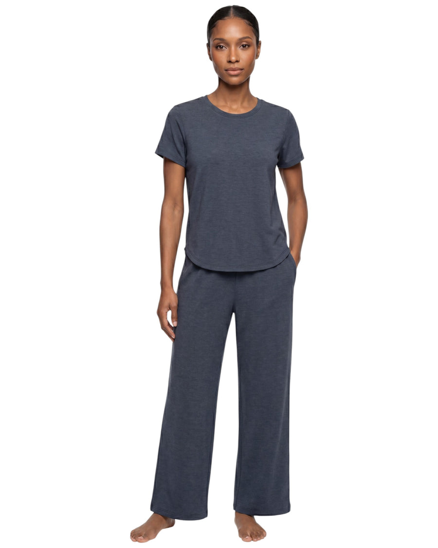 Model wearing a dark grey two-piece sportswear set with a relaxed short-sleeve top and wide-leg pants.

