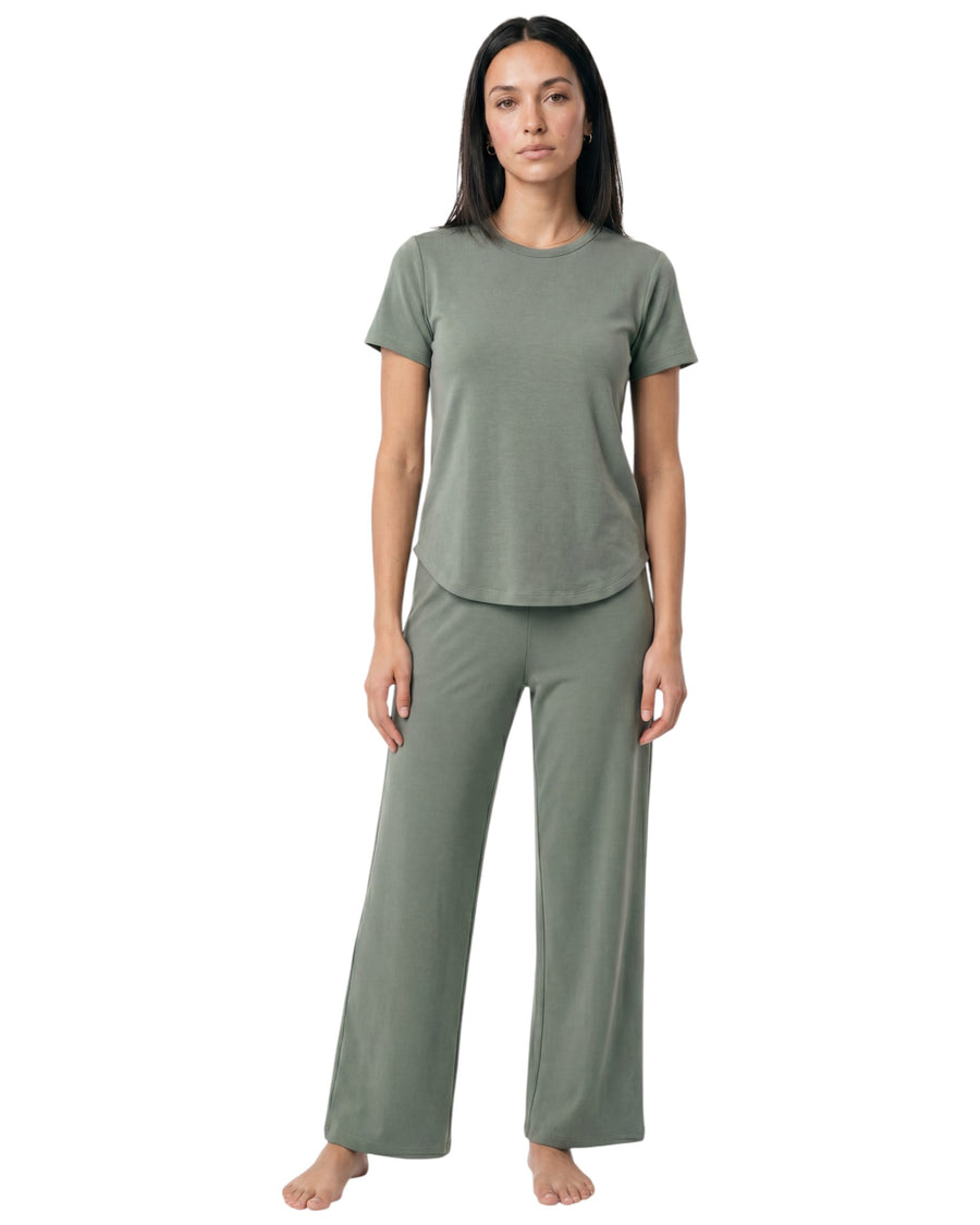 Model wearing a sage green two-piece sportswear set with a short-sleeve top and wide-leg pants.