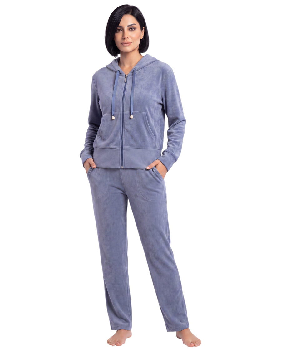 A woman modeling a matching two-piece loungewear set consisting of a zip-up hoodie and sweatpants in a heathered periwinkle blue colo