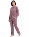 A woman modeling a matching two-piece velour loungewear set in a dusty mauve color, featuring a zip-up hoodie and matching pants