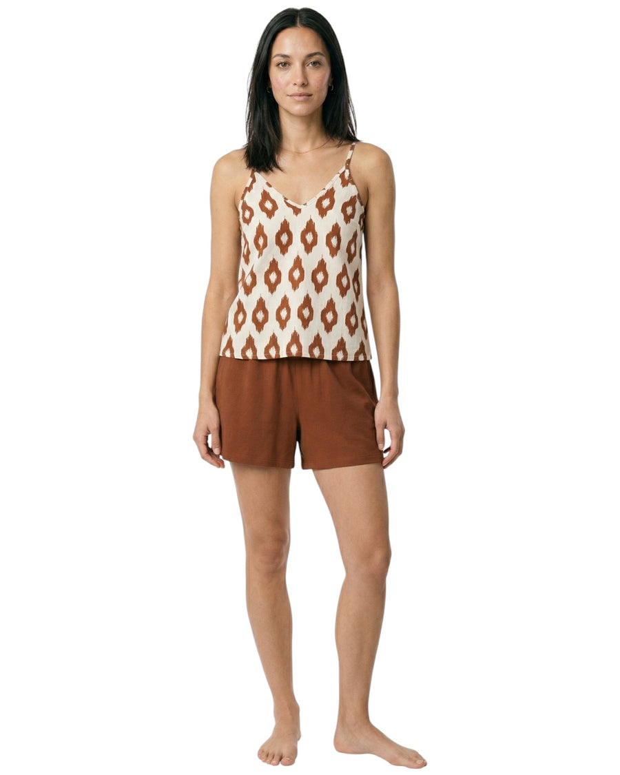 Model wearing a printed camisole lounge top with terracotta relaxed shorts.
