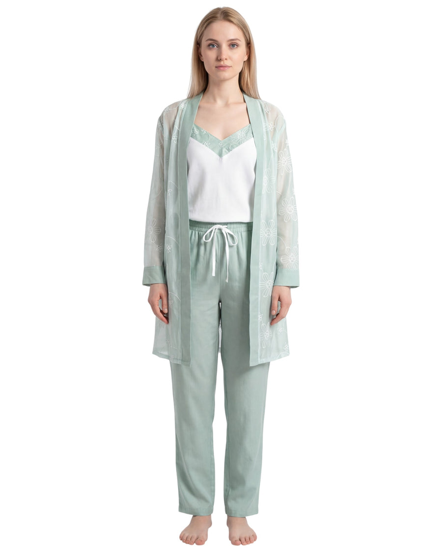Woman wearing a light green pajama set with a matching robe