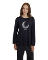 Woman wearing a navy pajama set with a moon design 