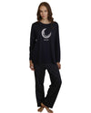 Woman wearing a navy pajama set with a moon design 