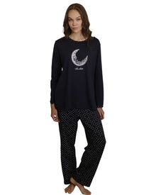  Woman wearing a navy pajama set with a moon design 