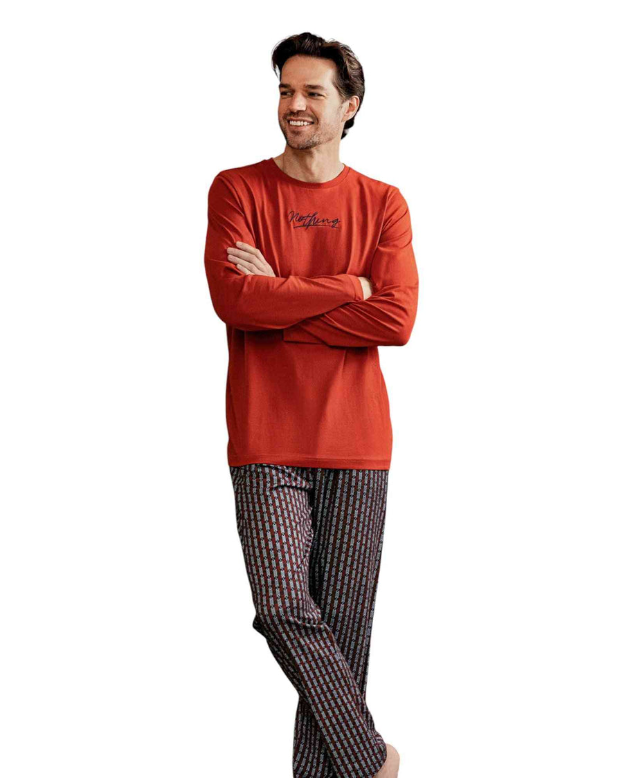 Man wearing a brick long-sleeve shirt and printed pants
