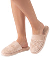 A pair of light beige plush slip-on slippers with textured floral embroidery on the upper