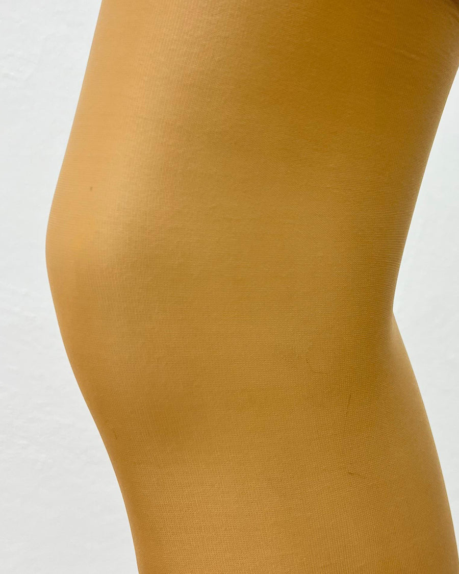 Close-up of nude Altas Knee Highs 15Den tights showing smooth, sheer texture. Shop Altas sheer tights for a flawless finish online.