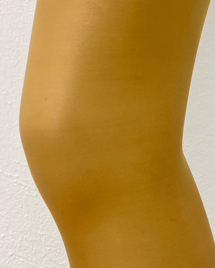 Golden nude Eleva Slimming Tights 20Den close-up, showing soft, sculpting fabric. Designed for comfort and a flattering fit.