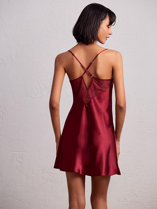 A back baby doll short dress with a unique back design featuring straps and cutouts. The dress has a flowy silhouette