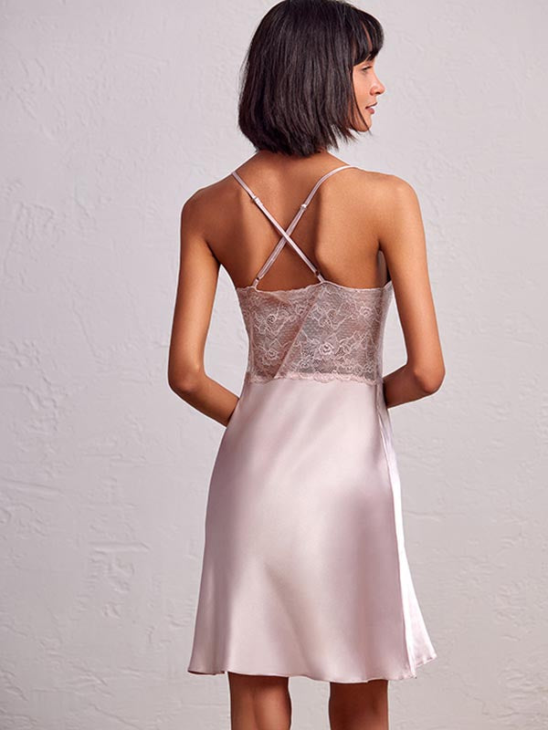 model wearing V-neck satin babydoll dress with intricate embroidery on the front and back. 