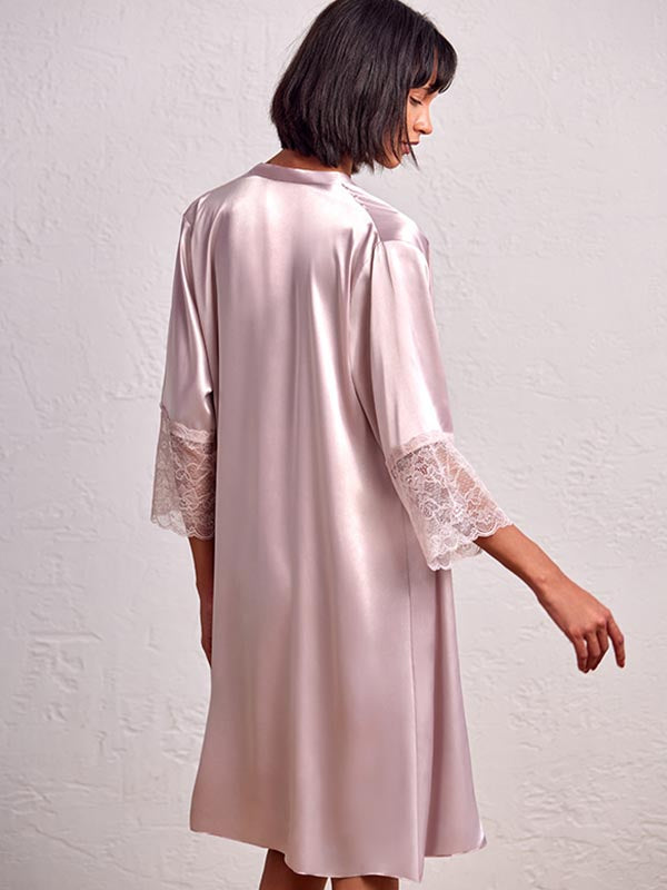 model wearing Short satin baby-doll robe in a soft pink color with hand-laced design on the front and plain back